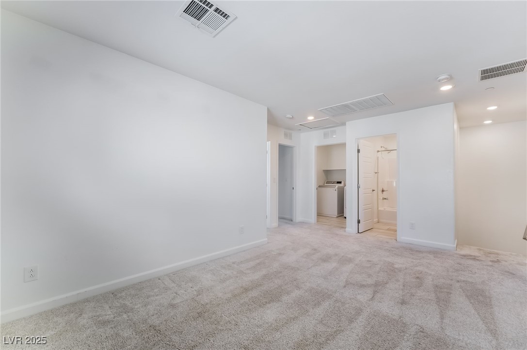 715 Pickled Pepper Place Henderson, NV 89011 - Photo 16 of 31 Unfurnished bedroom featuring carpet floors, recessed lighting, attic access, ensuite bathroom, and a walk in closet