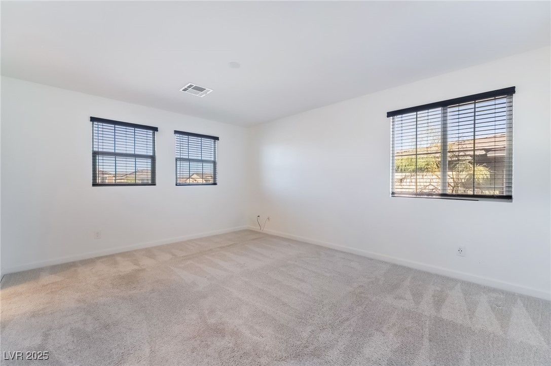 715 Pickled Pepper Place Henderson, NV 89011 - Photo 17 of 31 Spare room with light colored carpet and baseboards