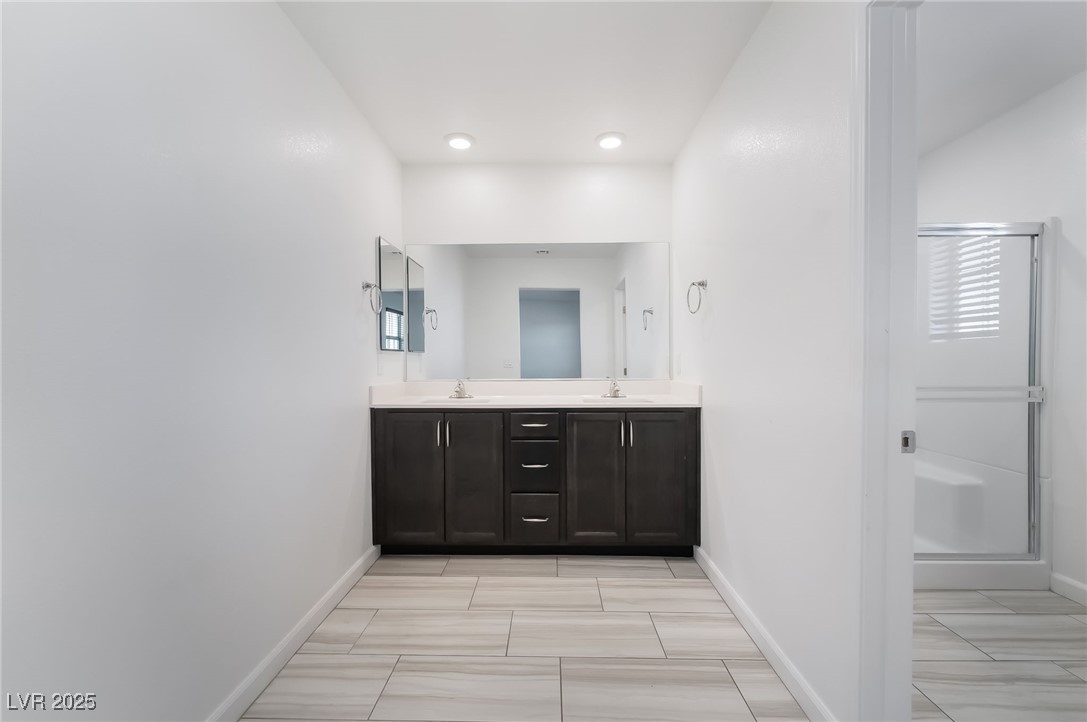 715 Pickled Pepper Place Henderson, NV 89011 - Photo 20 of 31 Full bath with double vanity and a shower stall