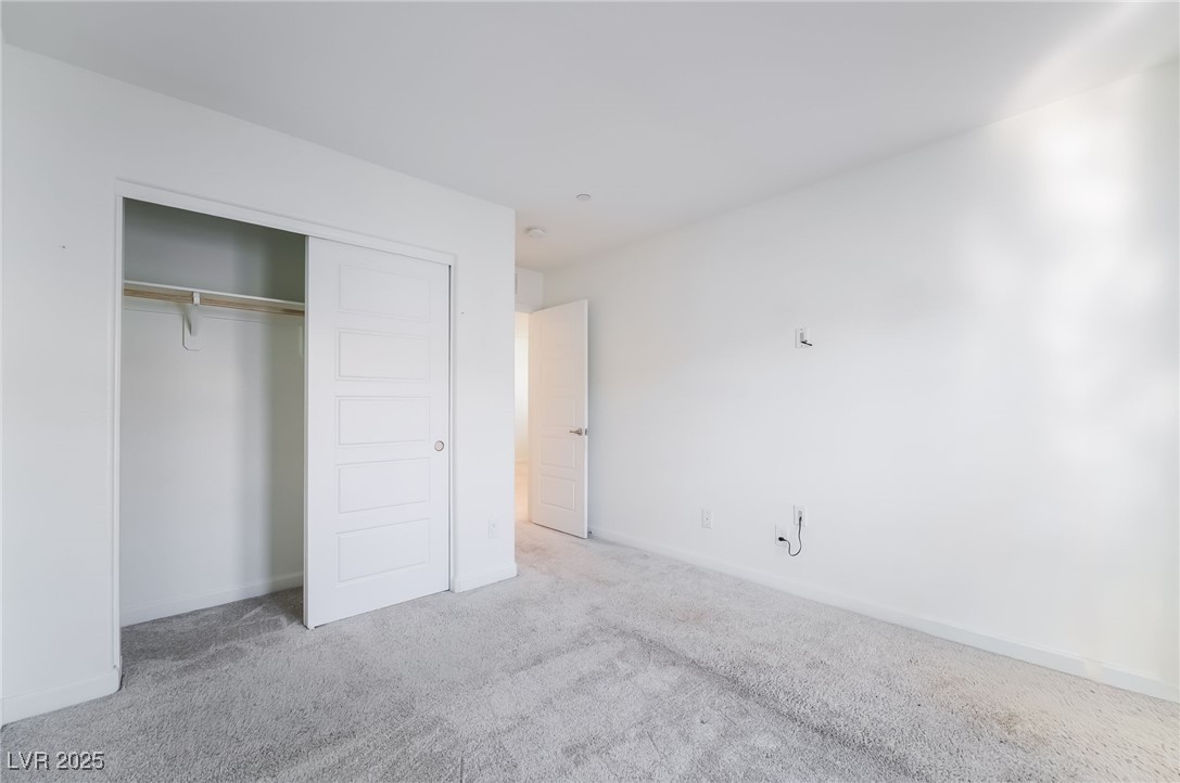 715 Pickled Pepper Place Henderson, NV 89011 - Photo 24 of 31 Unfurnished bedroom featuring carpet flooring and a closet