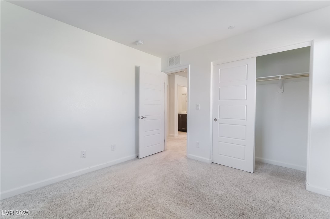 715 Pickled Pepper Place Henderson, NV 89011 - Photo 27 of 31 Unfurnished bedroom with light carpet and a closet
