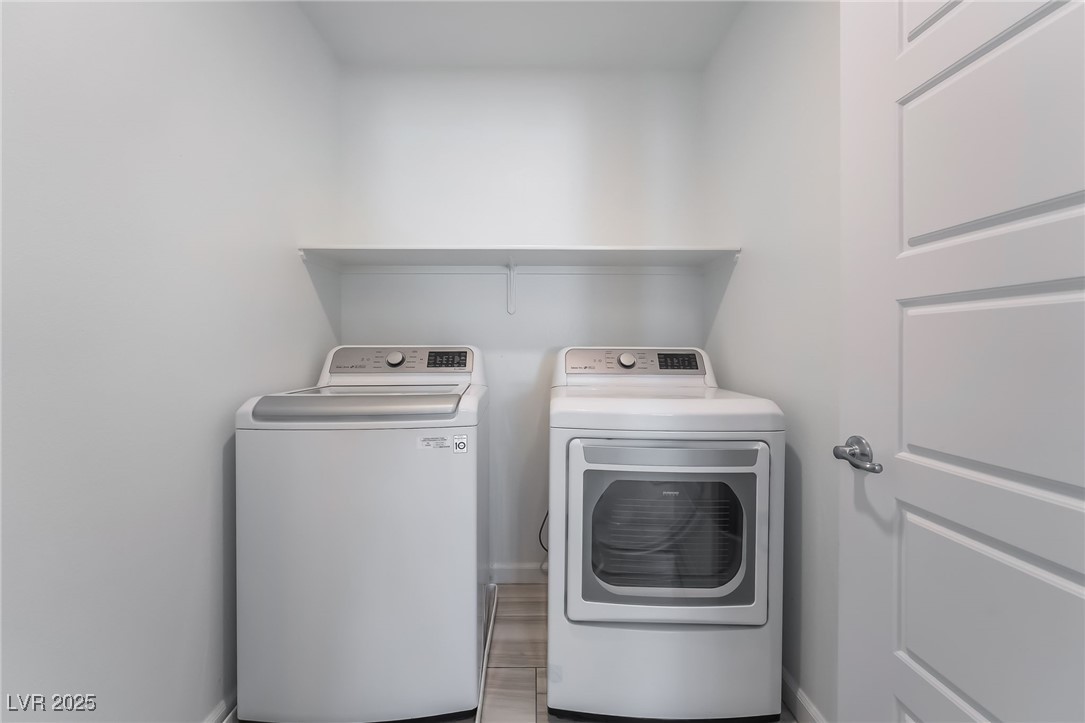 715 Pickled Pepper Place Henderson, NV 89011 - Photo 28 of 31 Laundry area featuring washing machine and clothes dryer and baseboards