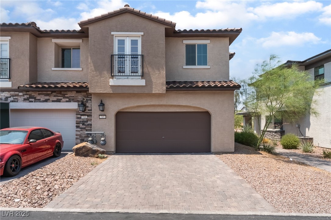 715 Pickled Pepper Place Henderson, NV 89011 - Photo 3 of 31 Mediterranean / spanish house with a balcony, stucco siding, and decorative driveway