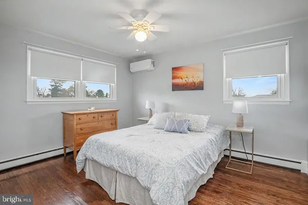 a bedroom with a bed and a painting on the wall