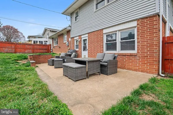 a view of a patio with table and chairs and potted plants