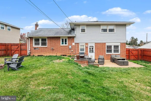 a front view of house with yard and outdoor seating