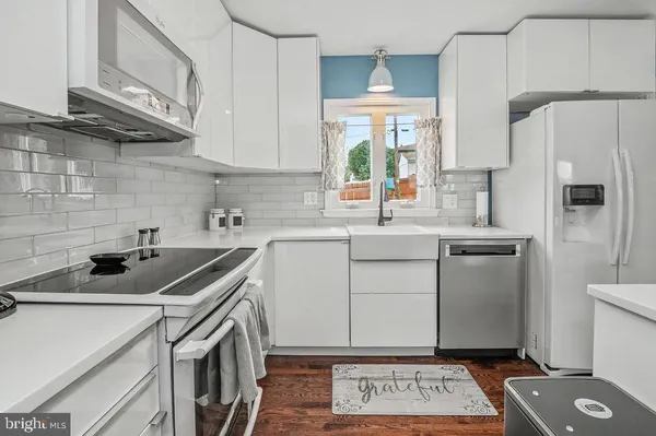 a kitchen with a sink a refrigerator a stove a washer and dryer