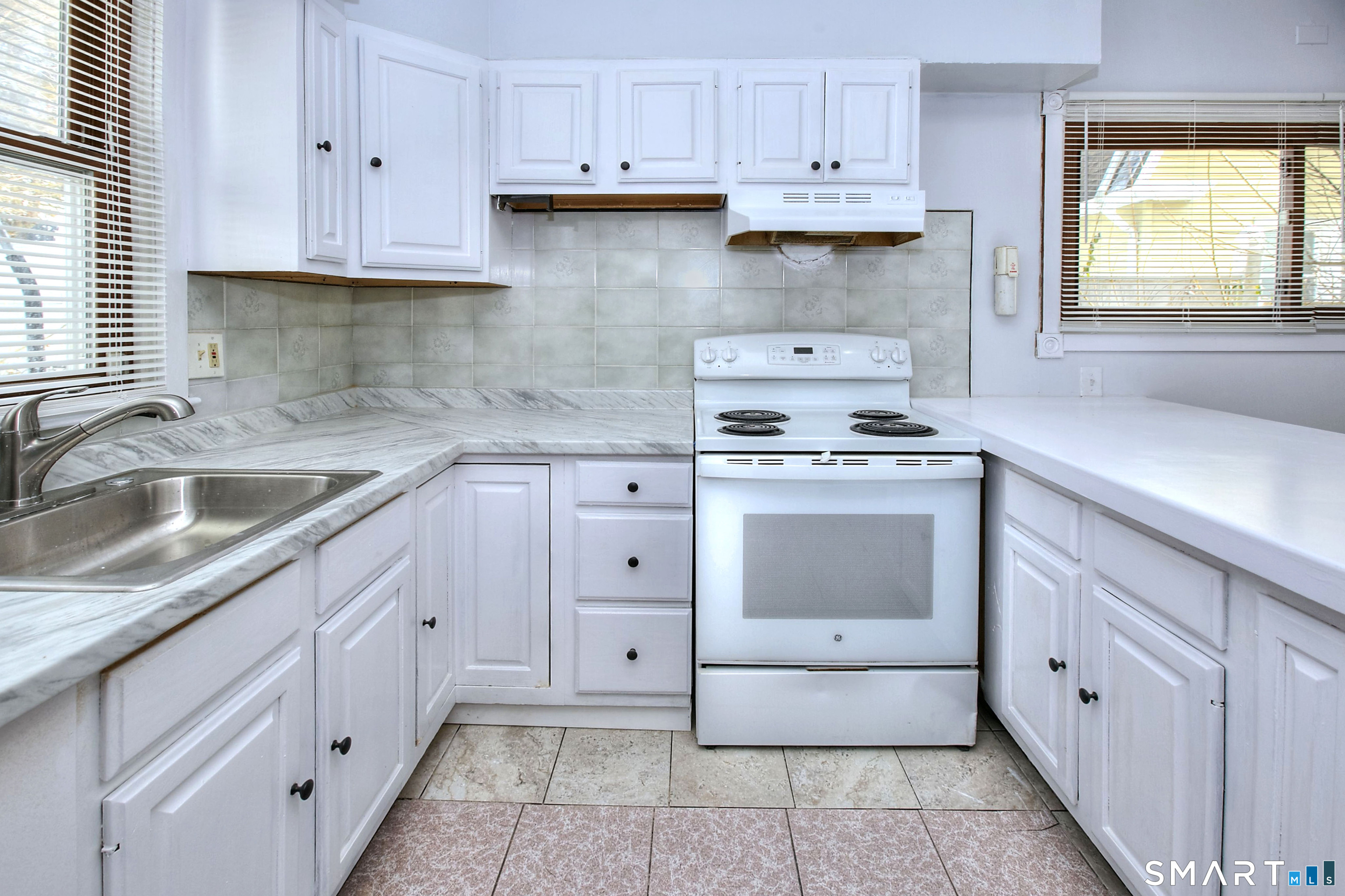 115 3rd Street Hamden, CT 06514 - Photo 13 of 34 a kitchen with cabinets appliances a sink and a window