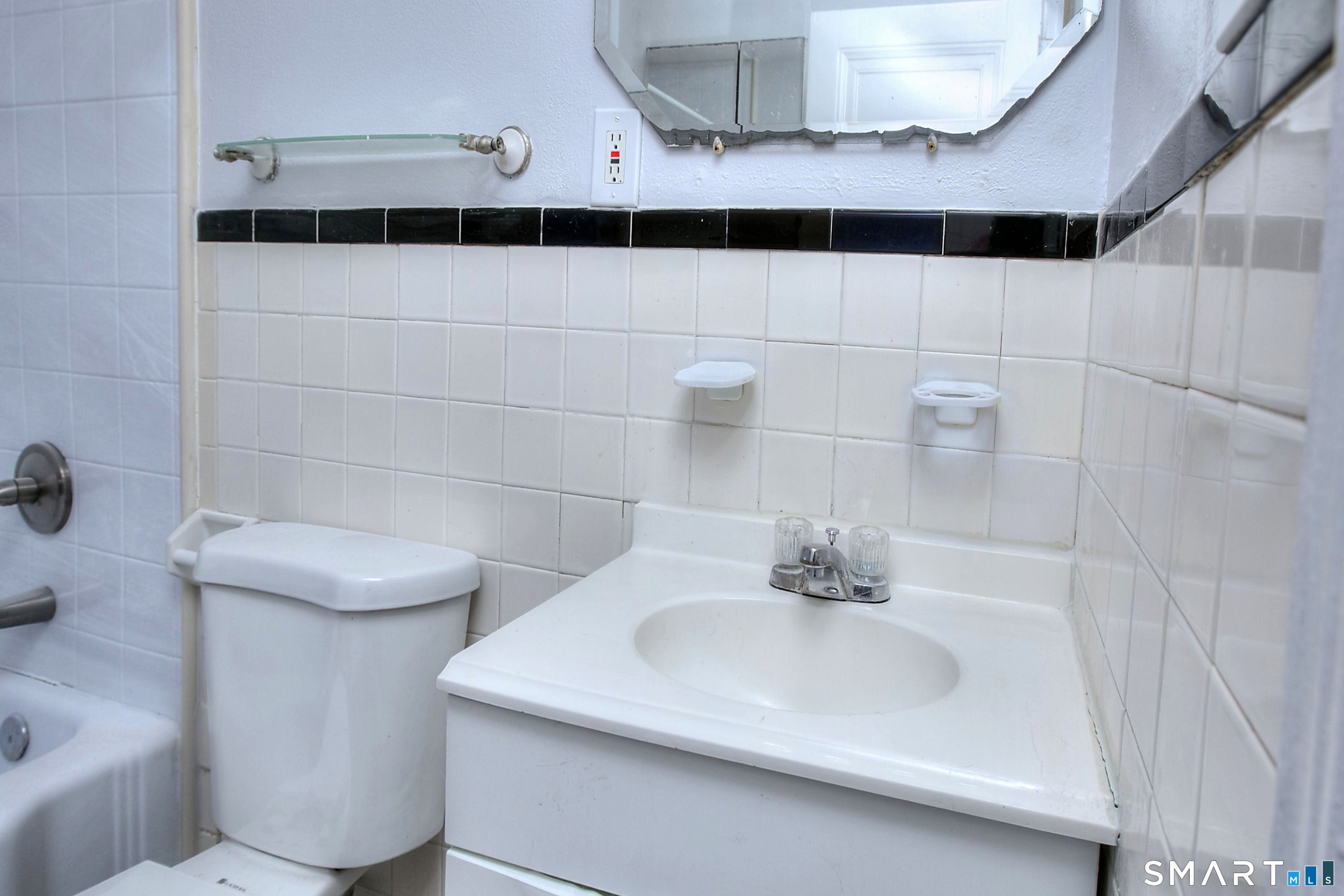 115 3rd Street Hamden, CT 06514 - Photo 15 of 34 a bathroom with a sink and a mirror