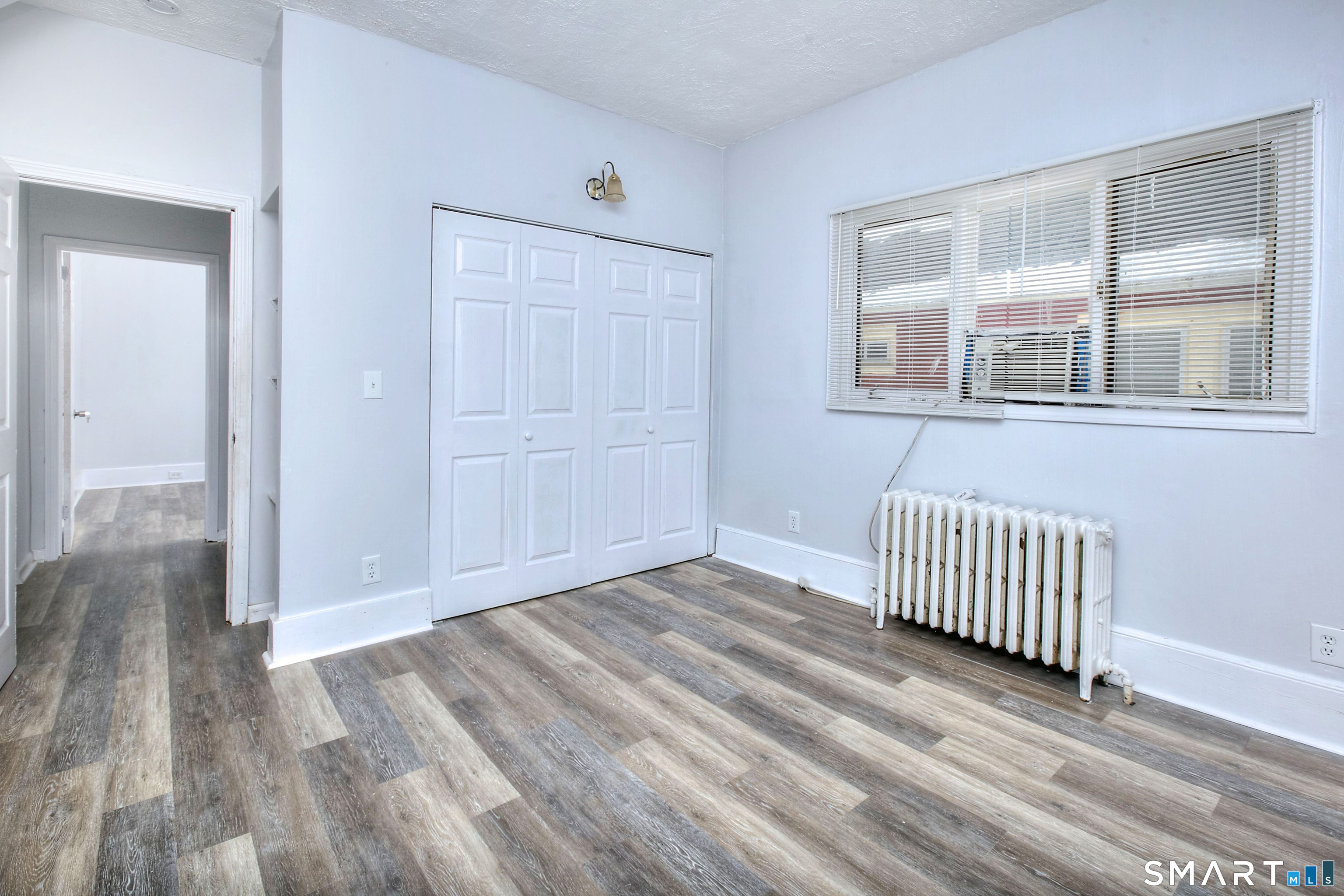 115 3rd Street Hamden, CT 06514 - Photo 20 of 34 a view of an empty room with wooden floor and windows