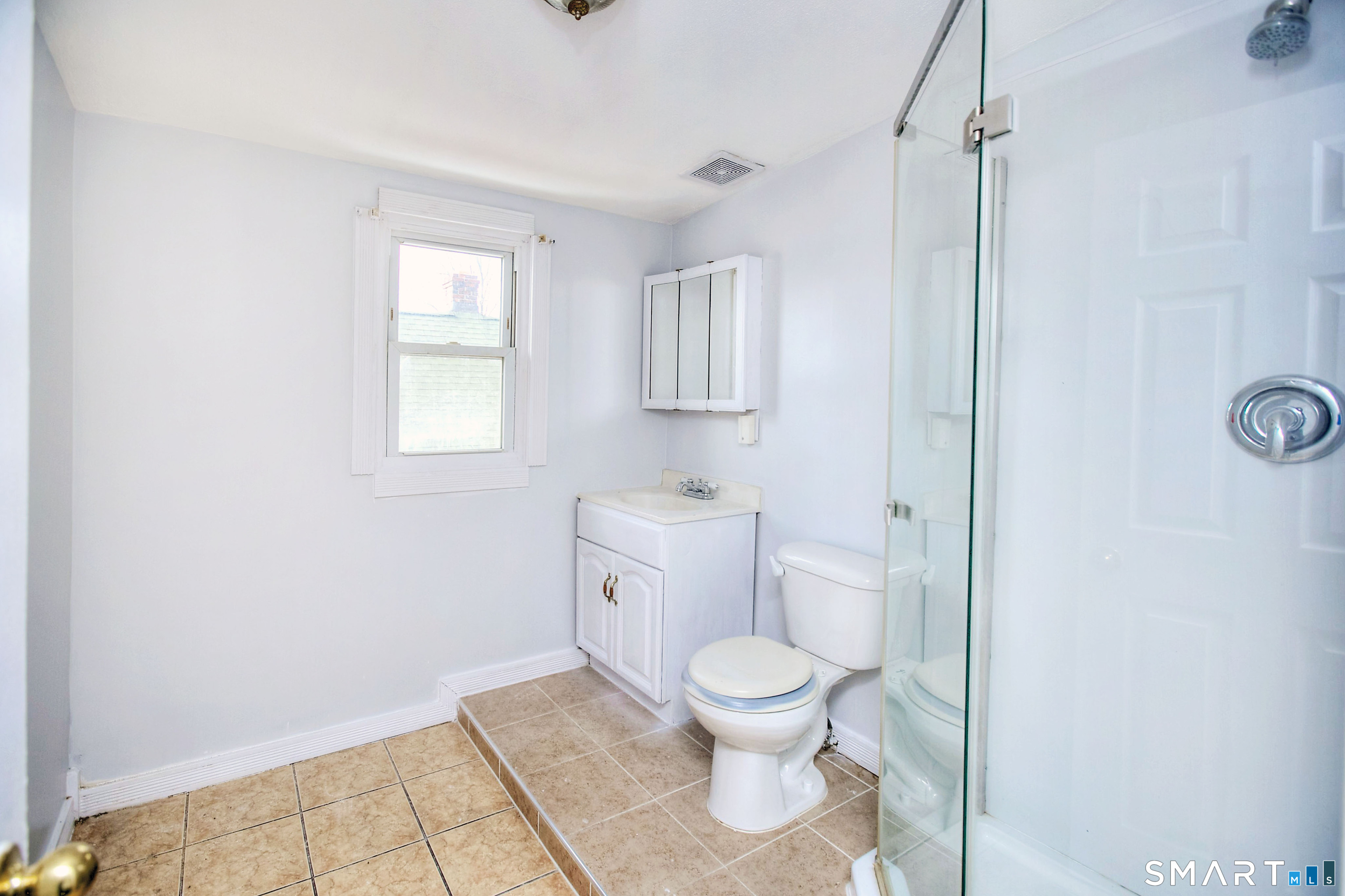 115 3rd Street Hamden, CT 06514 - Photo 27 of 34 a white toilet sitting next to a bathroom sink and vanity