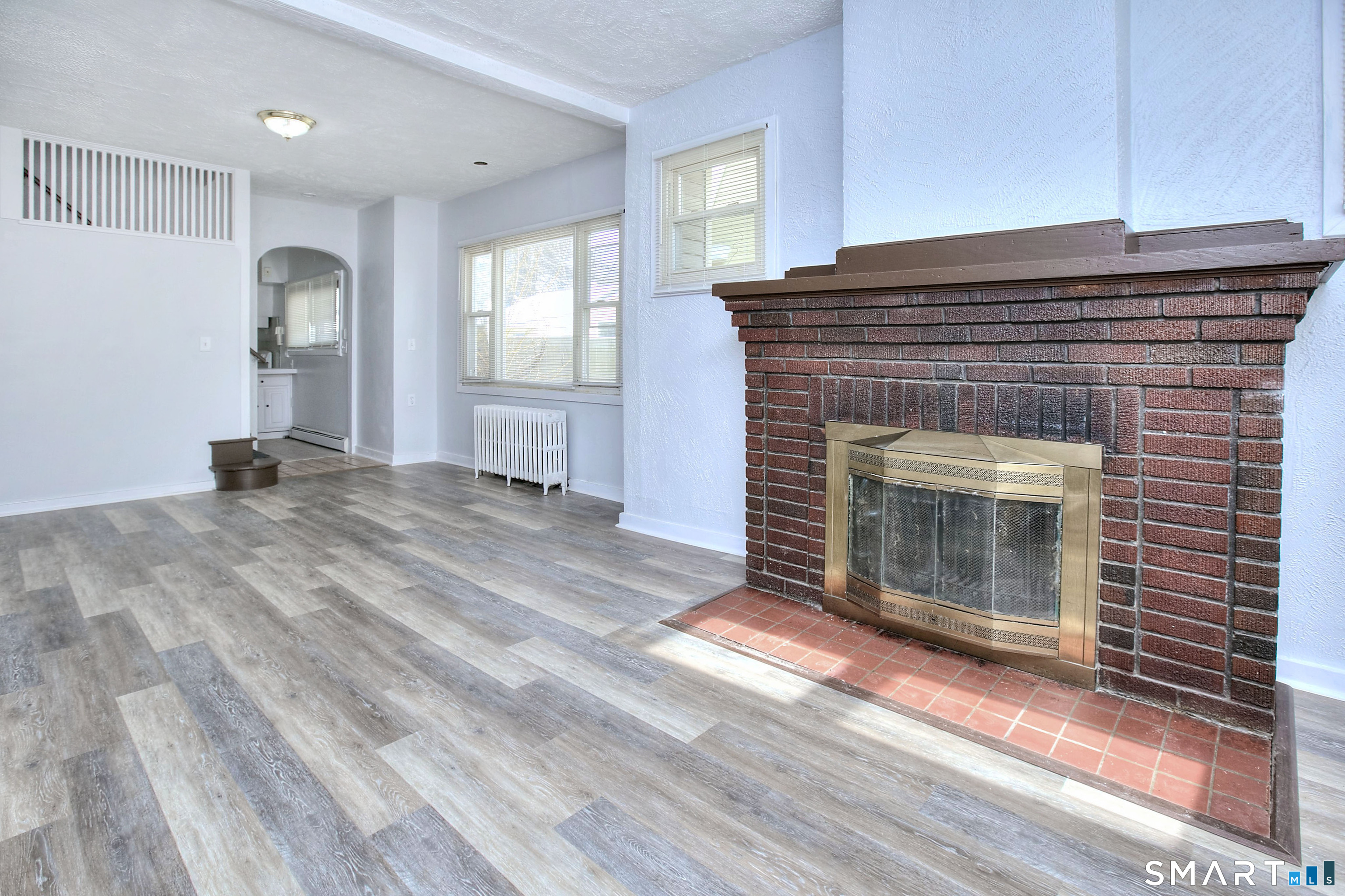 115 3rd Street Hamden, CT 06514 - Photo 5 of 34 a view of empty room with wooden floor and fireplace