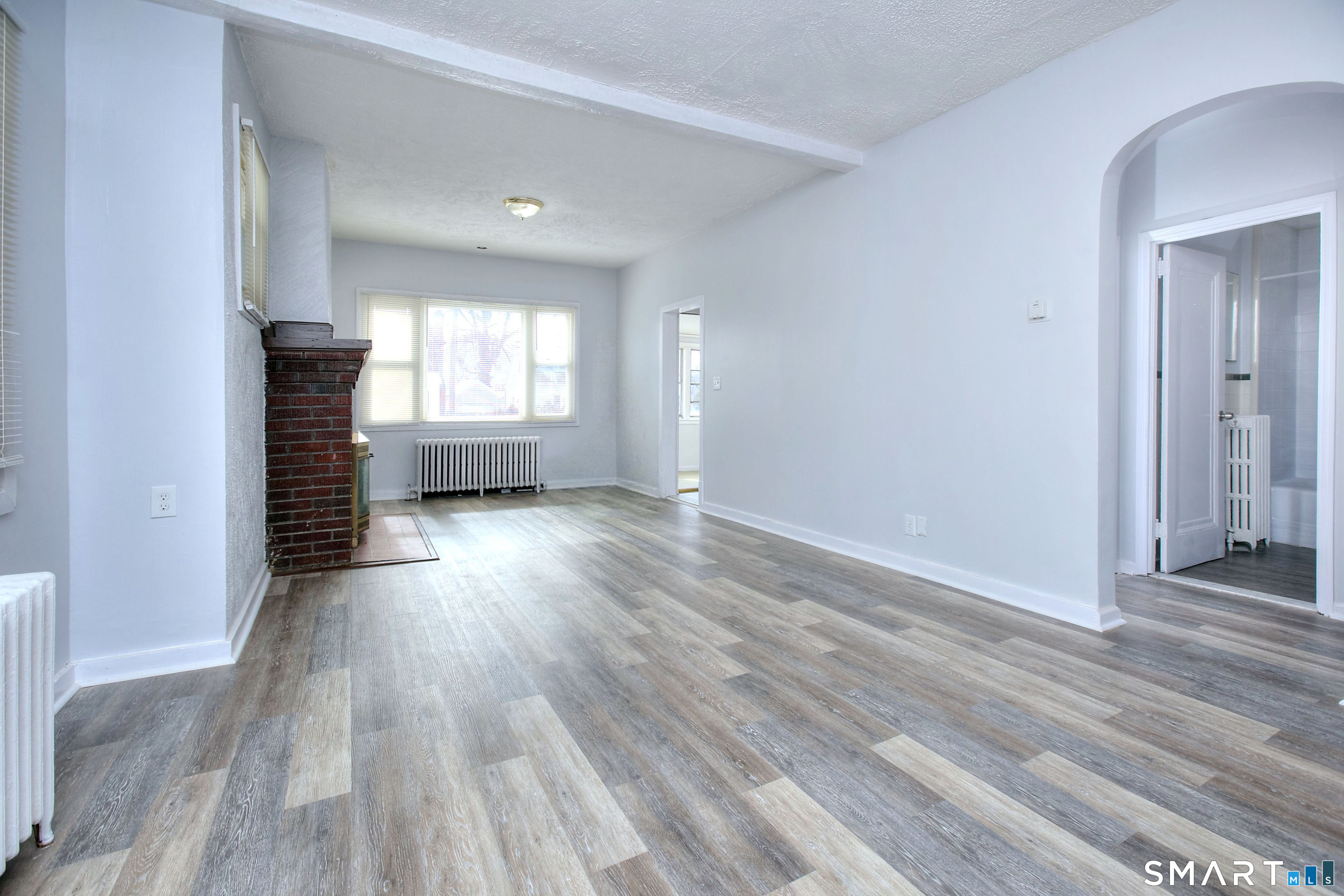 115 3rd Street Hamden, CT 06514 - Photo 6 of 34 an empty room with wooden floor and windows