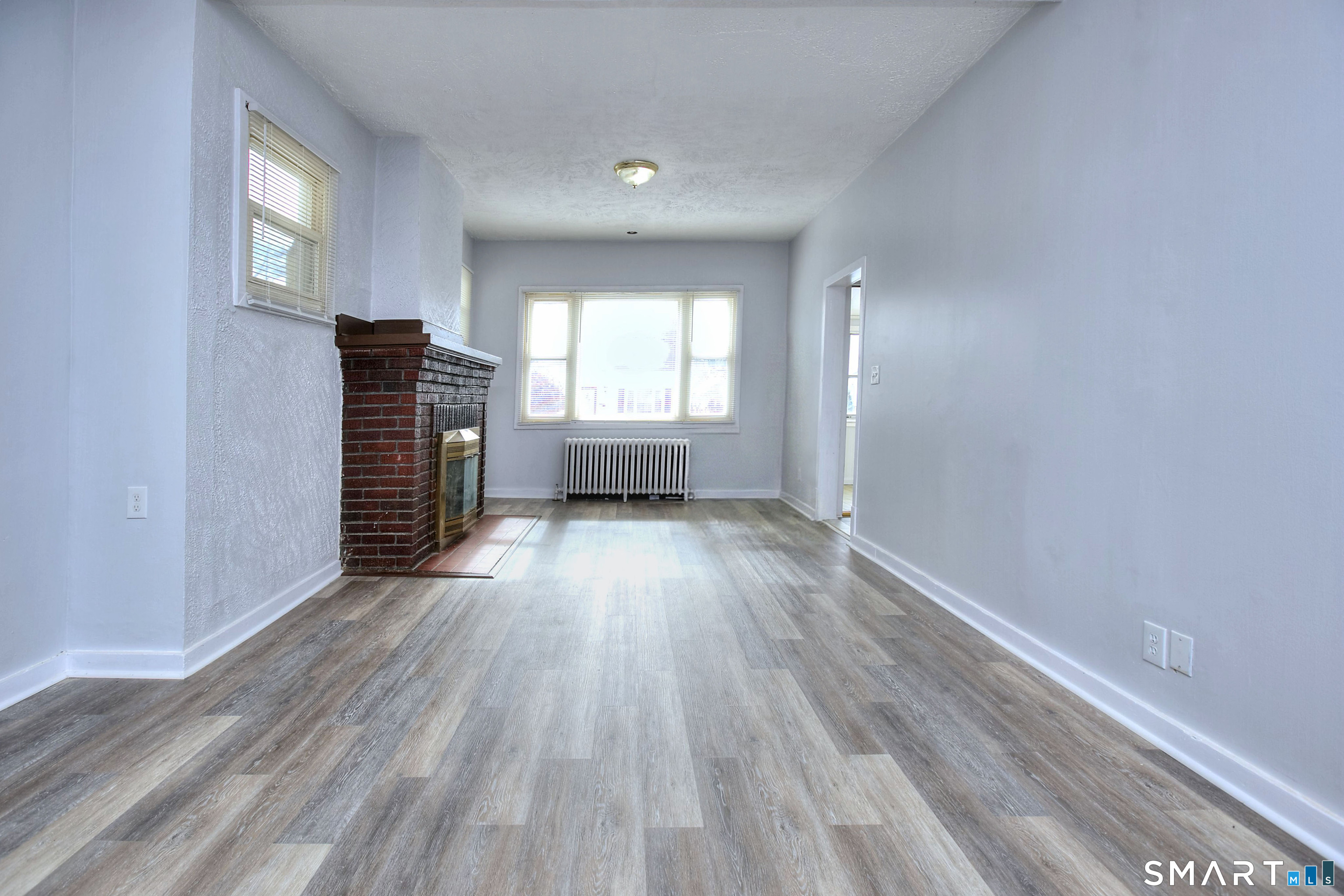 115 3rd Street Hamden, CT 06514 - Photo 7 of 34 a view of empty room with wooden floor and fan