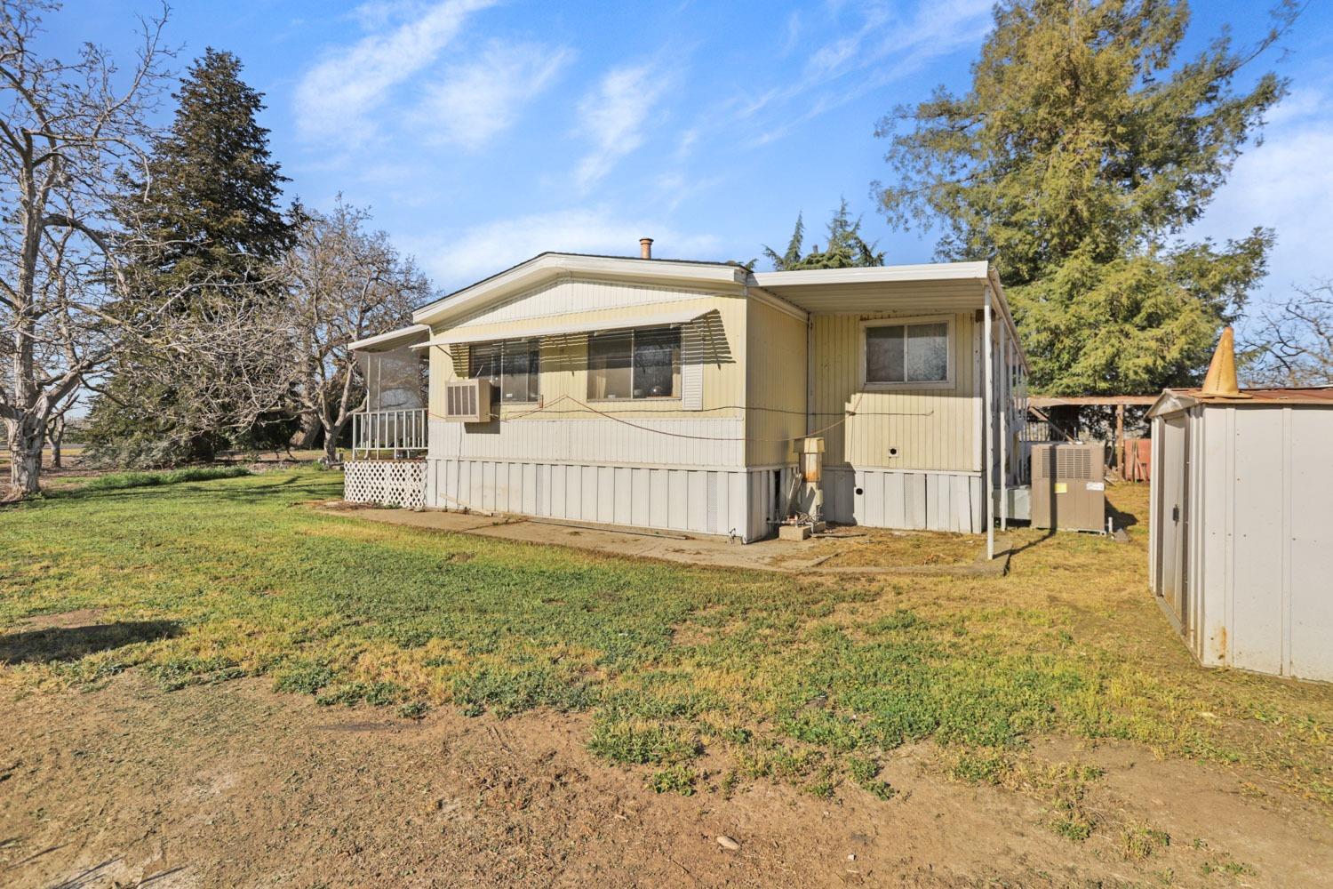 7622-7610 Alpine Road Stockton, CA 95215 - Photo 54 of 64 a front view of a house with a yard