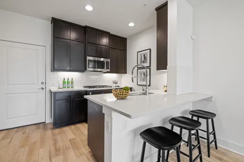 a kitchen with stainless steel appliances granite countertop a sink stove and cabinets