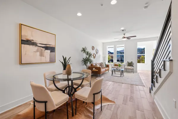 a living room with furniture and wooden floor