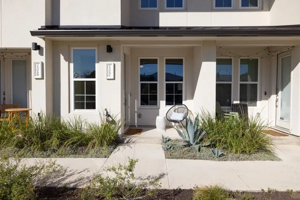 a balcony with a rug and a chair