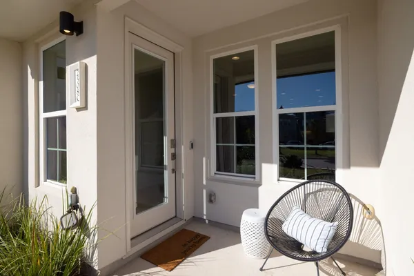 a view of a hallway with wooden floor and a dining room