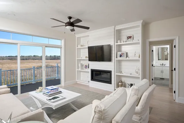 a living room with furniture a flat screen tv and a fireplace