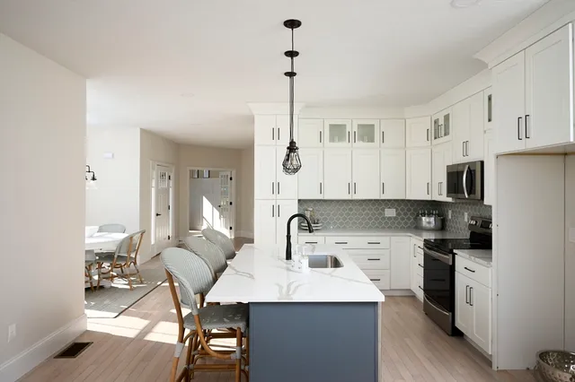 a kitchen with stainless steel appliances kitchen island granite countertop a sink and cabinets