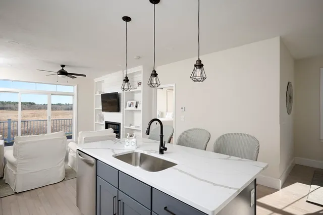 a kitchen with a sink a center island and furniture