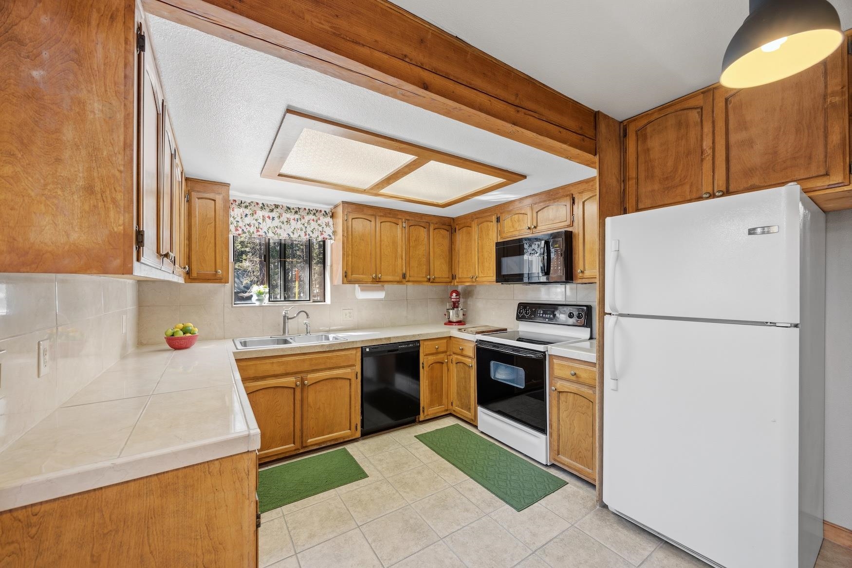21146 Donner Pass Road Soda Springs, CA 95728 - Photo 6 of 25 a kitchen with stainless steel appliances granite countertop a refrigerator sink and stove