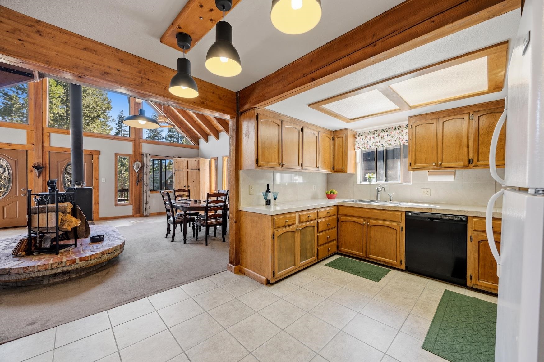 21146 Donner Pass Road Soda Springs, CA 95728 - Photo 7 of 25 a large kitchen with stainless steel appliances granite countertop a stove and cabinets