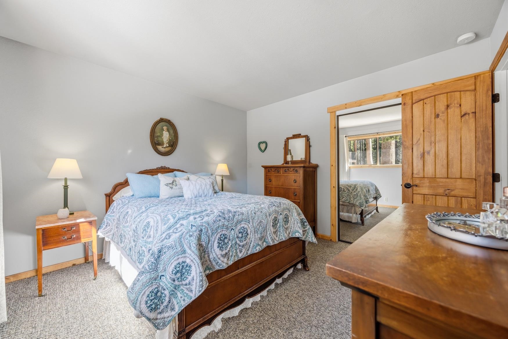 21146 Donner Pass Road Soda Springs, CA 95728 - Photo 8 of 25 a bedroom with a bed and a lamp next to a window