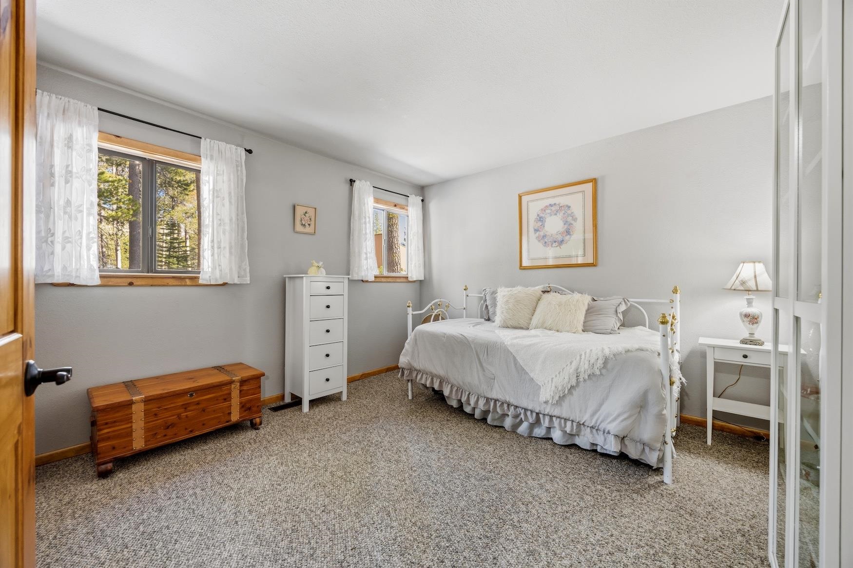 21146 Donner Pass Road Soda Springs, CA 95728 - Photo 9 of 25 a spacious bedroom with a bed and a cabinets