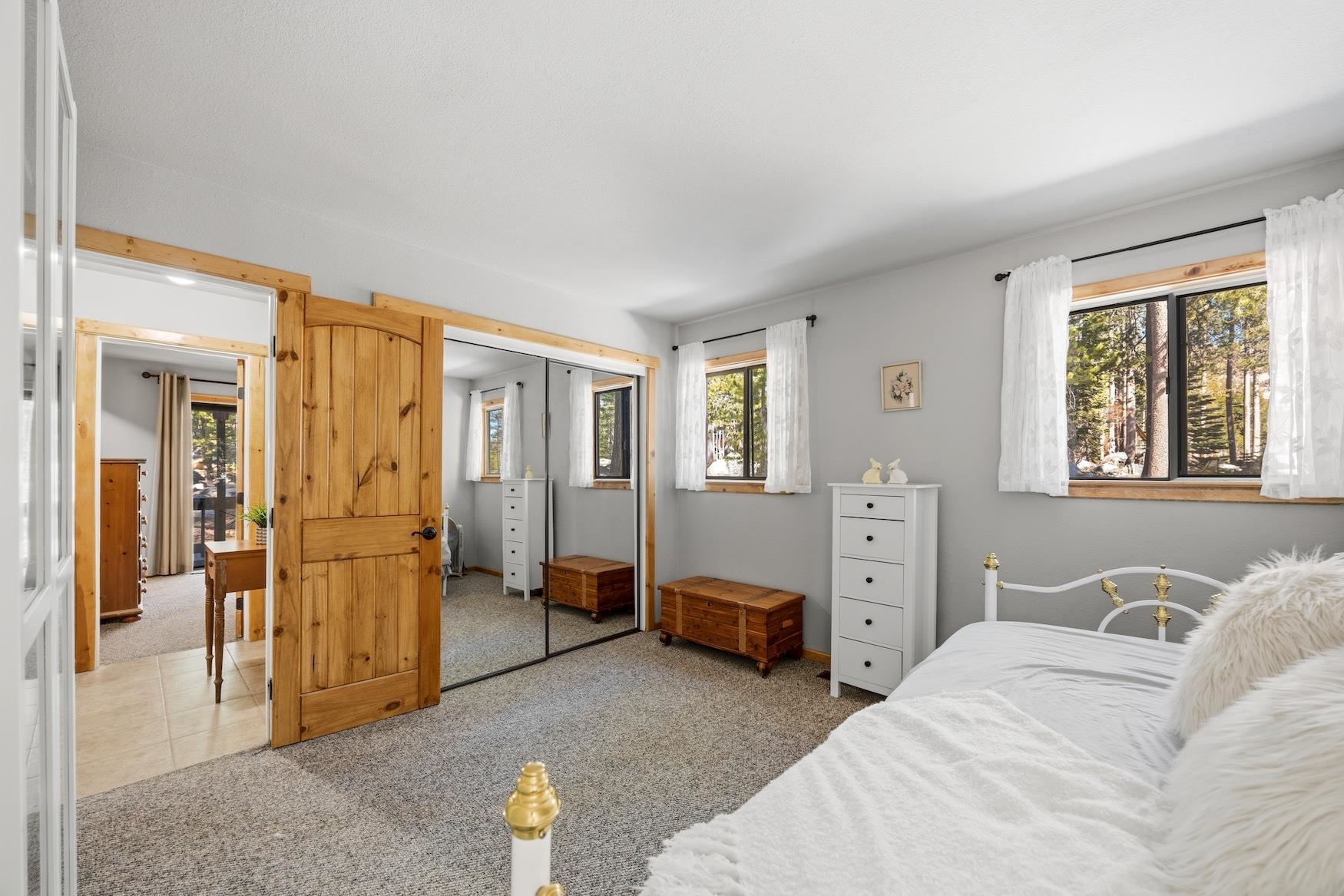 21146 Donner Pass Road Soda Springs, CA 95728 - Photo 10 of 25 a spacious bedroom with a bed and wooden floor