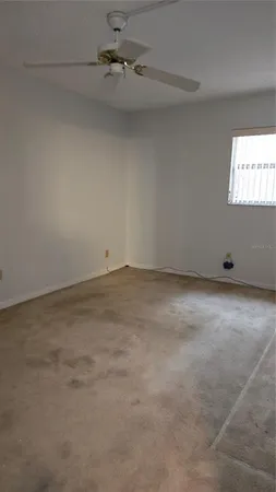 a view of an empty room and a window