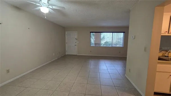 an empty room with windows and entrance
