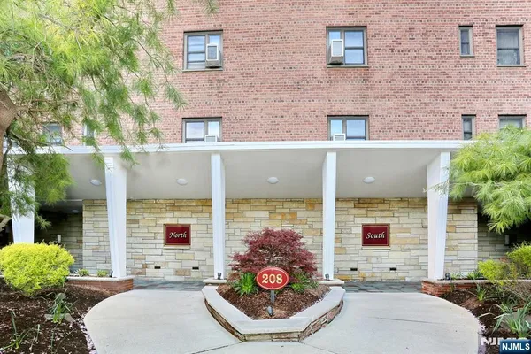 a view of a patio with couches table and chairs and potted plants