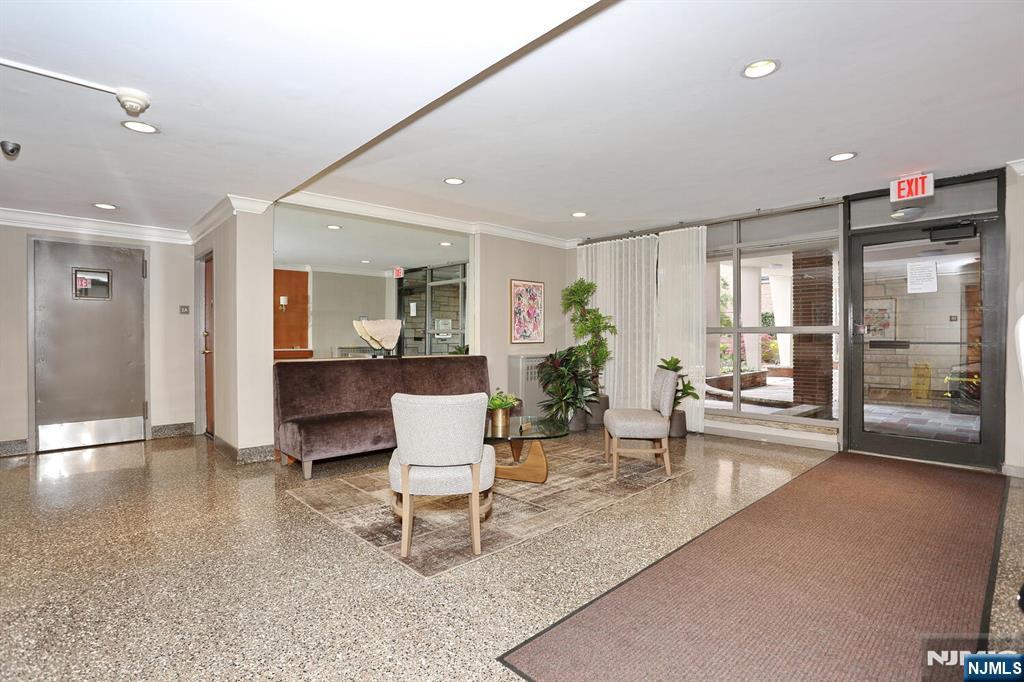 208 Anderson Street, Unit S4F Hackensack, NJ 07601 - Photo 15 of 20 a living room with furniture a table and chairs
