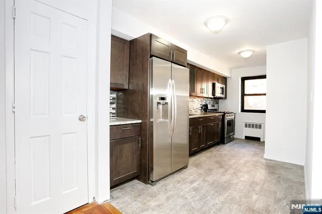 a kitchen with stainless steel appliances a refrigerator and a sink