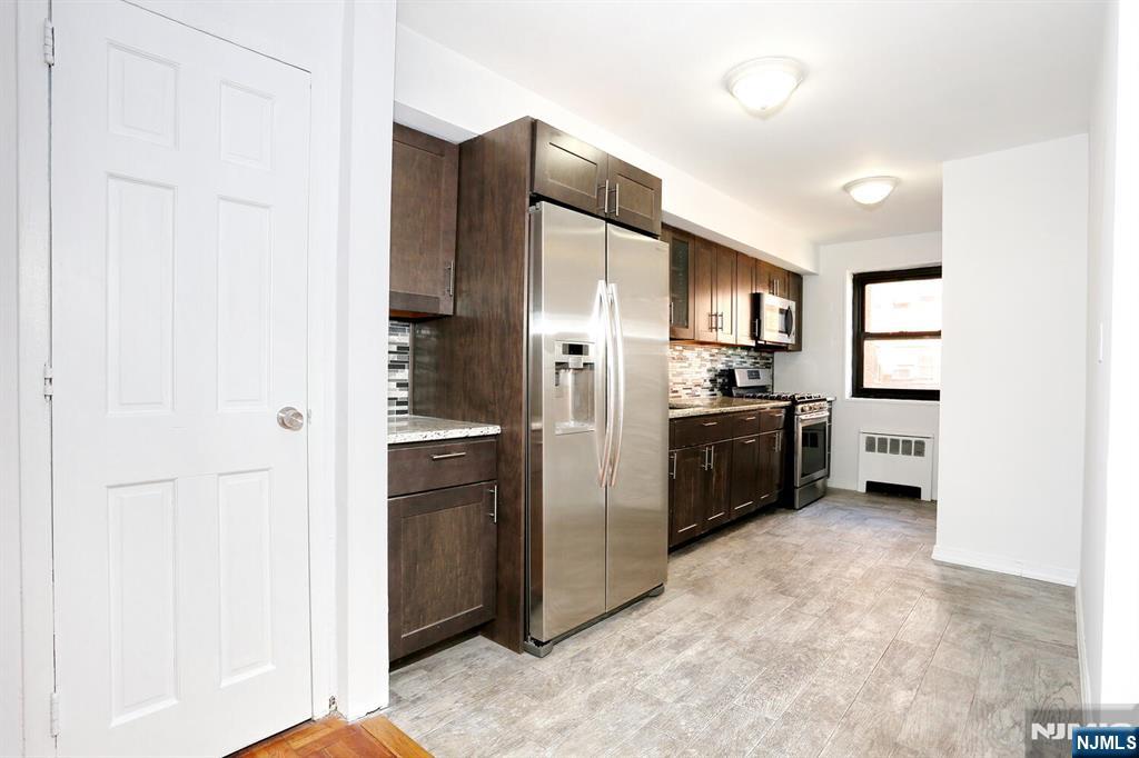 208 Anderson Street, Unit S4F Hackensack, NJ 07601 - Photo 3 of 20 a kitchen with stainless steel appliances a refrigerator and a sink