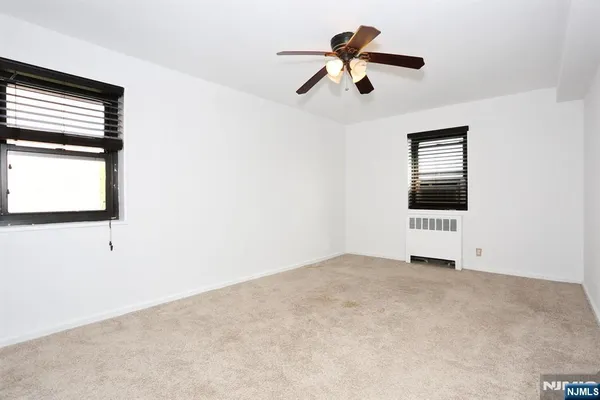 a view of a ceiling fan and a window