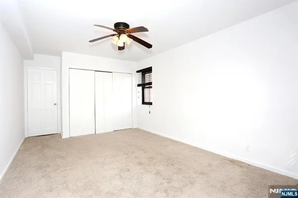 a view of a room with a ceiling fan