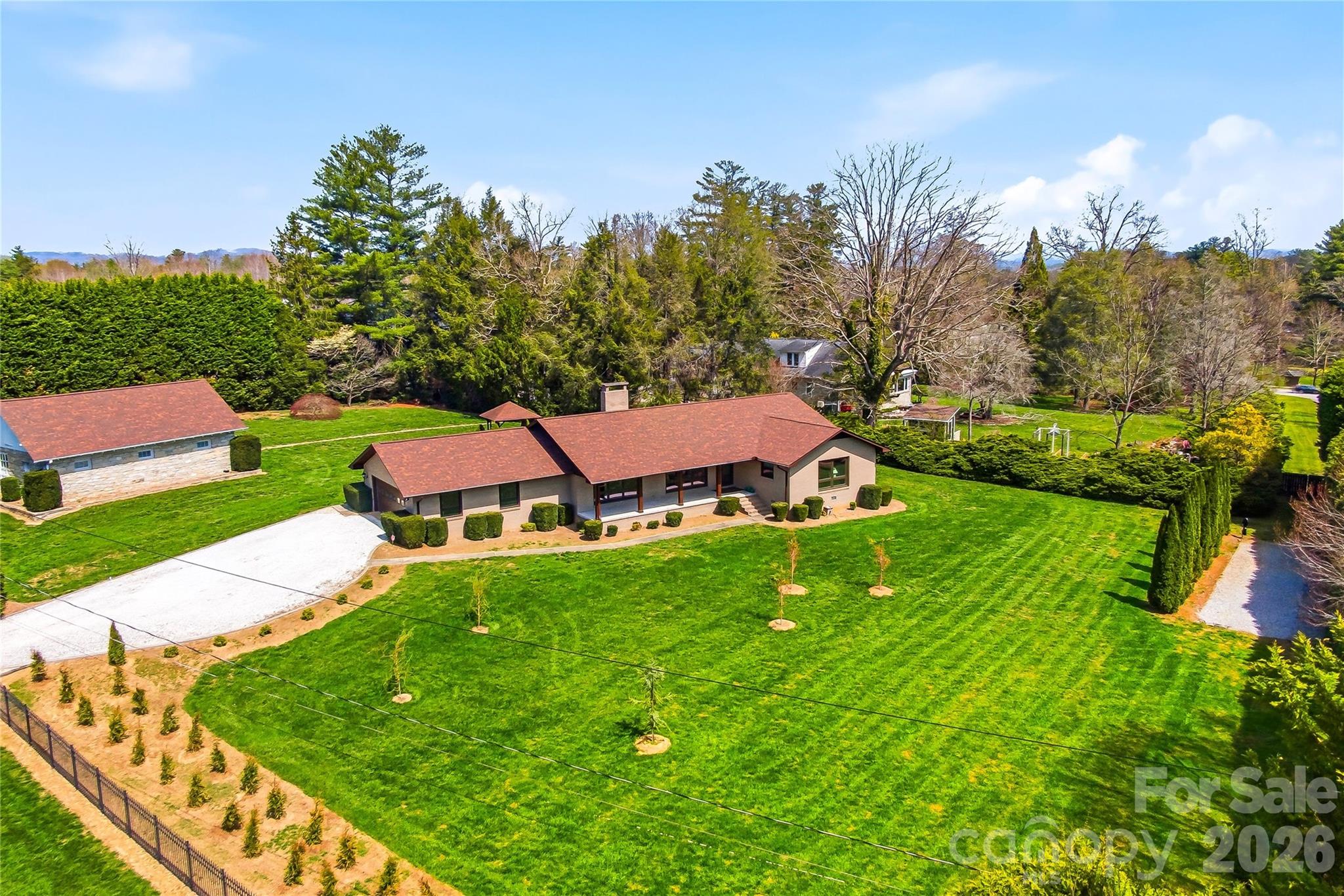 a aerial view of a house with swimming pool garden and outdoor seating