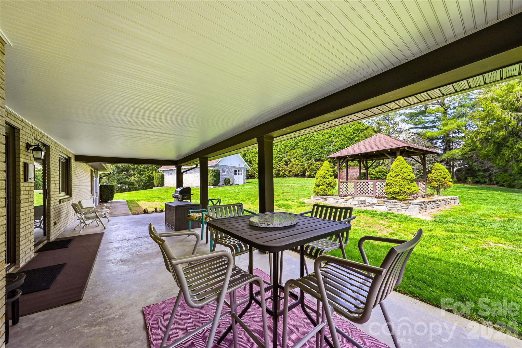 910 Rutledge Annex Hendersonville, NC 28739 - Photo 27 of 45 a view of a patio with a table chairs and a backyard