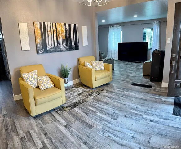 a view of a dining room with furniture and wooden floor