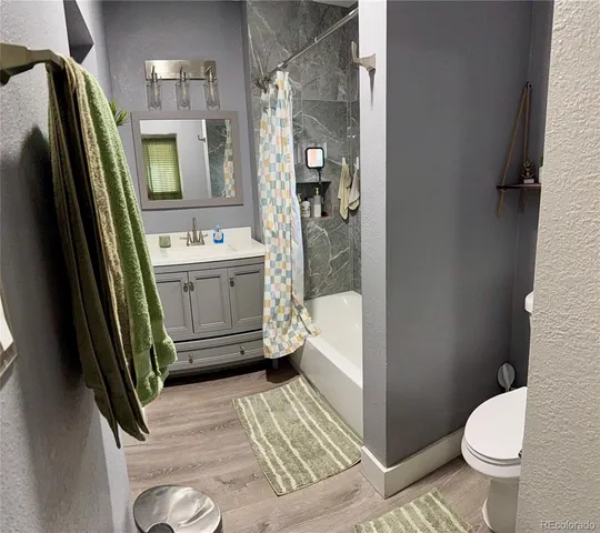a bathroom with a sink a mirror and a shower curtain