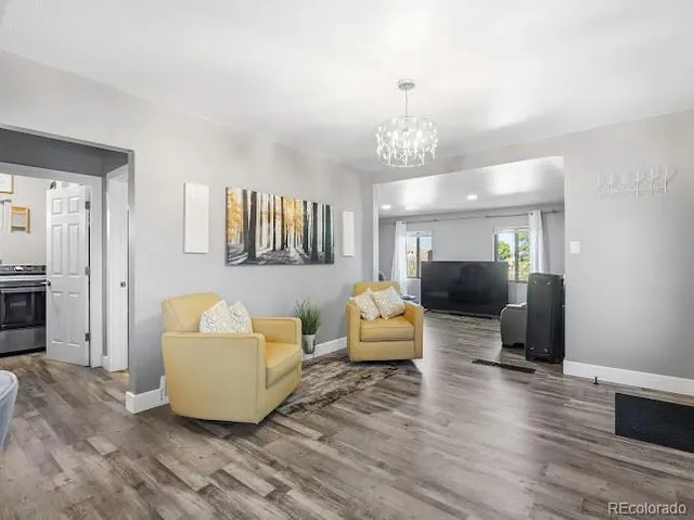 a kitchen with a stove and a wooden floor