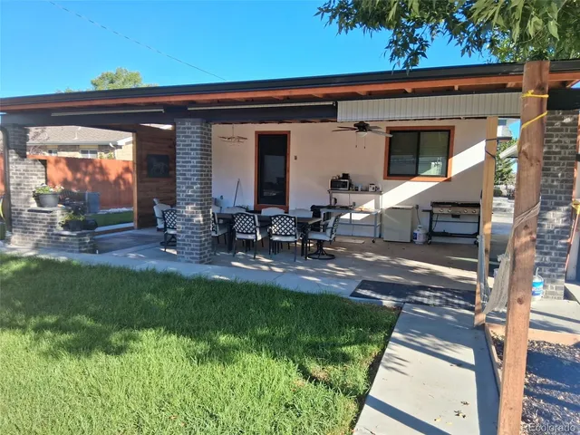 a backyard of a house with table and chairs