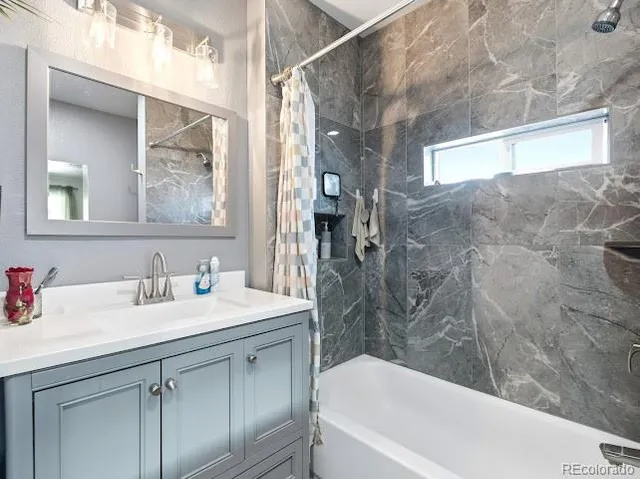 a bathroom with double sink and a mirror