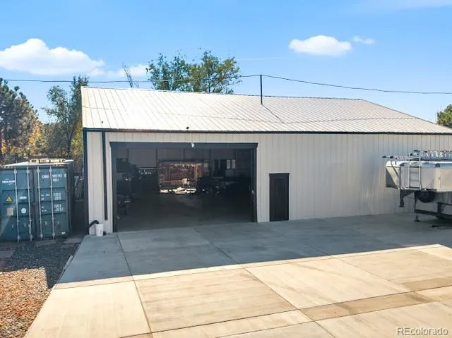 a view of a patio with table and chairs a barbeque and potted plants