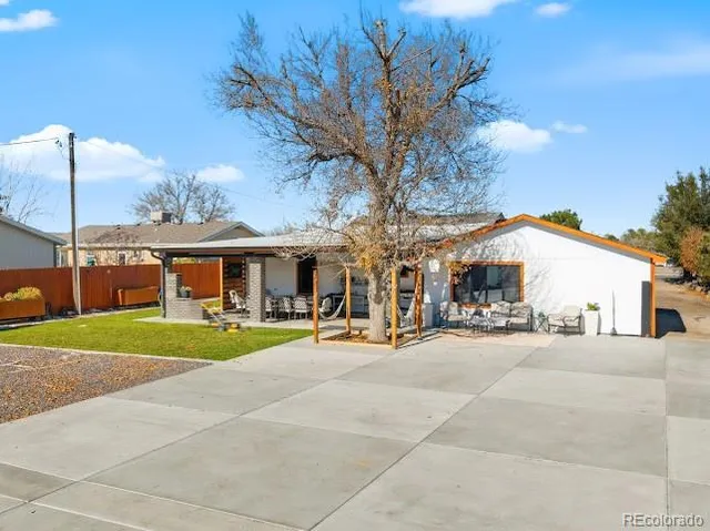 a view of a big house with a big yard and large trees