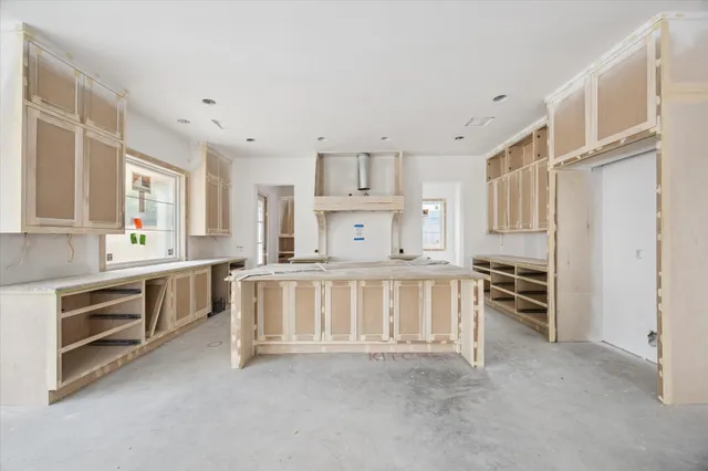 a kitchen with stainless steel appliances a stove top oven