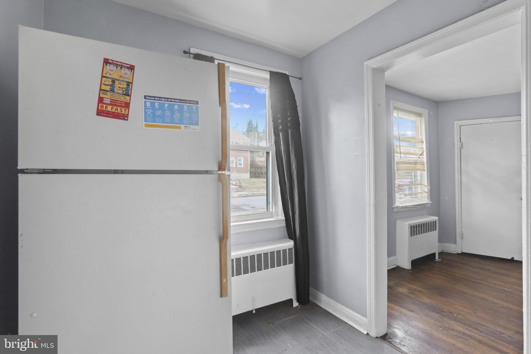 4511 Fairfax Road Baltimore, MD 21216 - Photo 14 of 35 a view of a hallway with closet and wooden floor